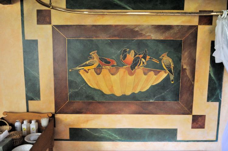 Image ural of a flock of birds on a conch shell painted to look like Roman stone inlay